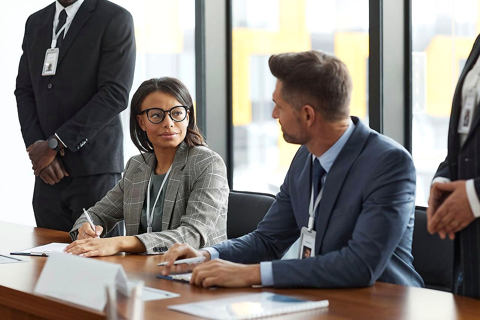 Free Diverse business professionals discussing strategy during a modern board meeting. Stock Photo